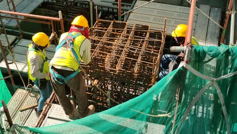 Construction-workers-fabricating-steel-reinforcement-bars-at-the-construction-site