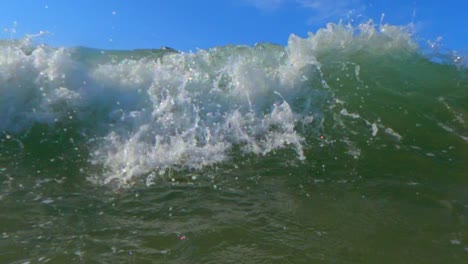 Person-have-fun-splashing-with-big-sea-waves-breaking