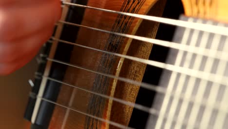 Macro-shot-of-acoustic-guitar-strings-being-played