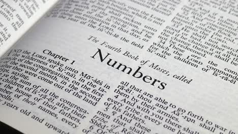 Close-up-shot-of-Bible-Turning-to-the-Book-of-Numbers