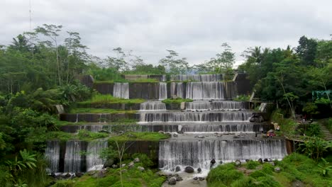 Aerial-forward-drone-view-of-Watu-Purbo-waterfall-in-Muntilan,-Indonesia
