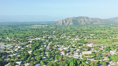 Aerial-view-Over-Suburb-of-Caribbean-Neiba-City-situated-in-Lush-Natural-Mountains-Area-of-Beautiful-Greenery,-Dominican-republic