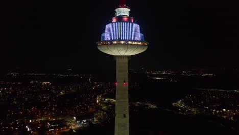 AERIAL:-Peaceful-and-Slow-Pedestal-Shot-of-Vilnius-TV-Tower-at-Night