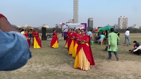 Bengali-girls-dressed-in-colorful-Indian-dresses,-dancing-at-Dol-utsab-or-Holi-festival