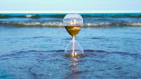 Hourglass-filled-with-sand-on-the-beach,-time-out-concept,-background-of-time-flow-measurement