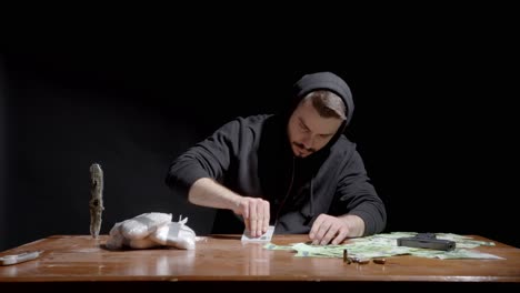 Drug-Addict-Uses-Card-In-Forming-Lines-Of-Cocaine-On-The-Table-For-Snorting