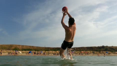 Boy-in-sea-water-jumps-to-save-ball-kicked-from-beach