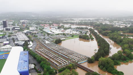 Aerial-view-of-houses,-schools-and-train-station-coming-close-to-flooded-waters-during-the-2022-QLD-Floods-Robina-Gold-Coast-QLD-Australia