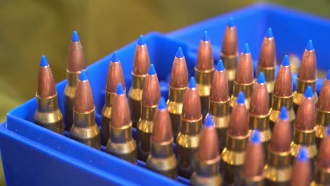 Blue-ammunition-box-full-of-223-caliber-military-grade-bullets-with-blue-plastic-tip-for-rapid-expansion---Slider-from-left-to-right