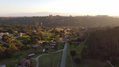 Small-iconic-USA-town-surrounded-by-green-valley,-aerial-drone-view