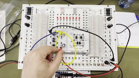 Engineer-Hand-Experimenting-With-Electronic-Components-On-Breadboard