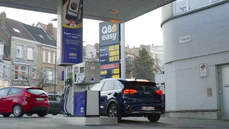 Interactive-sign-displaying-all-time-high-gas-prices-at-Q8-Easy-gas-station-as-cars-are-going-and-leaving