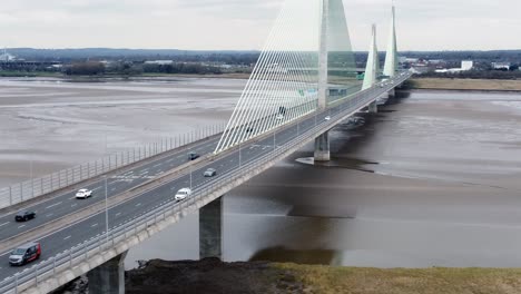 Mersey-gateway-landmark-aerial-view-above-toll-suspension-bridge-river-crossing-traffic-tracking-reverse-shot