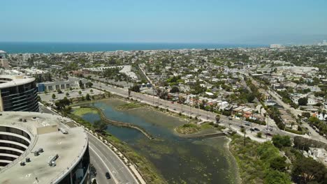 Aerial-shot-of-buildings-and-roads-near-a-California-Beach