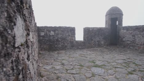 Pan-over-the-stone-battlements-of-Castle-Marvão-hiding-in-the-mist