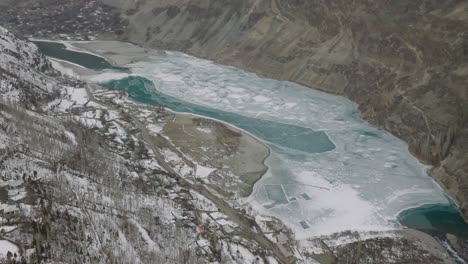 Aerial-Flying-Over-Frozen-khalti-lake-Valley-With-Turquoise-River