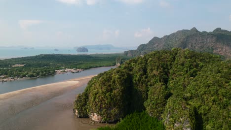 Drone-revealing-a-large-sandbar,-mangroves-and-mountains-in-Ao-Thalane-Krabi-Thailand-on-a-sunny-day