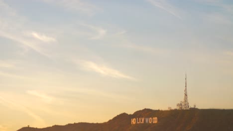 Tilt-down-shot-of-the-iconic-Hollywood-sign-in-a-distance-at-sunset