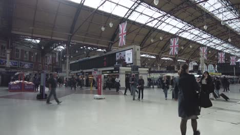 Inside-View-Of-Passengers-Walking-Past-At-Busy-London-Victoria-Station-On-12-April-2022