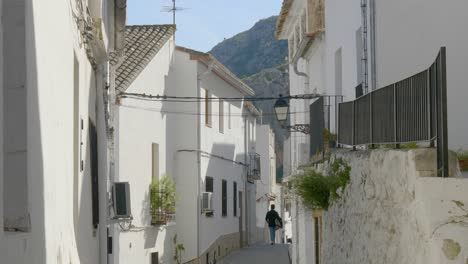 A-young-couple-walking-down-the-narrow-Spanish-streets-in-the-small-village-of-Chulilla