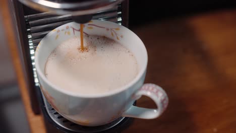 Espresso-dripping-into-mug-then-picked-up-slow-motion-4k-30fps