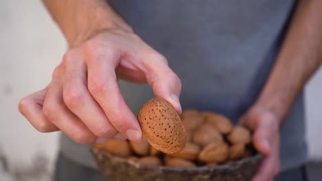 Man-Showing-Almond-Nuts-In-Shell-On-Camera