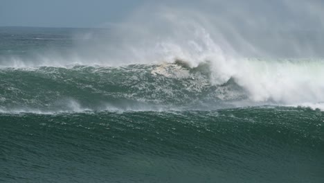Surfers-paddle-over-huge-wave-and-bail