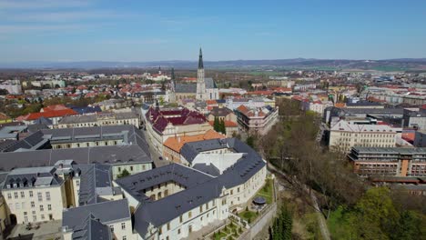 Aerial-Drone-Over-European-City-Of-Olomouc-With-Rooftops-And-Church-Steeple-On-Clear-Day-In-Autumn-In-Czech-Republic