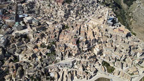 Aerial-drone-top-shot-showing-the-whole-town-of-Matera,-Italy