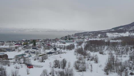 aerial-view-over-Olderdalen,-Village-in-Kåfjord,-Norway-on-a-cloudy-winter-day