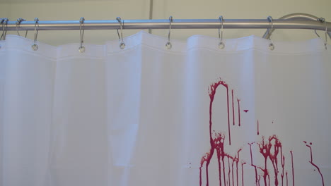 Medium-shot-of-blood-spraying-on-a-shower-curtain