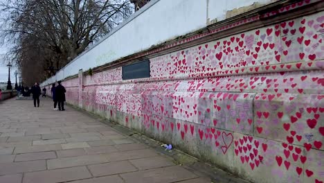 LONDON,-circa-2021---Some-150,000-red-hearts-are-painted-on-the-National-Covid-Memorial-Wall-in-London-to-honour-each-of-the-UK-Covid-19-victims