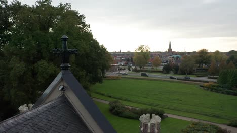 High-angle-view-from-artwork-on-roof-of-old-mansion-overlooking-green-garden