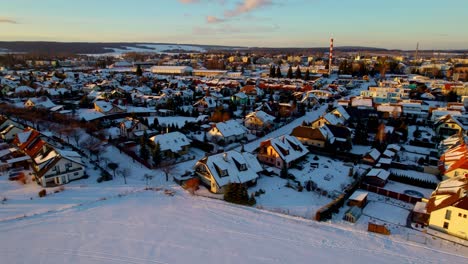 Aerial-drone-video-showing-a-scenic-view-of-a-town-covered-with-thick-white-layers-of-snow-in-winter