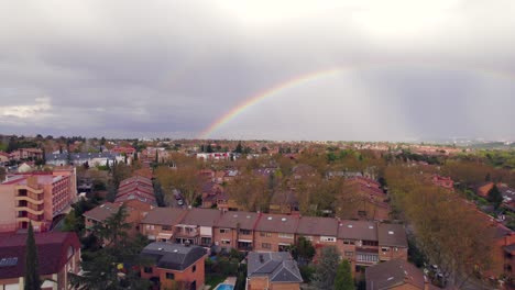 Colorful-rainbow-in-the-sky-over-residential-Spanish-neighborhood