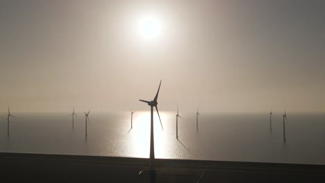 Aerial-towards-Wind-turbines-spinning-on-Epic-Windpark-on-Sea-with-bright-sunlight,-Renewable-Enery