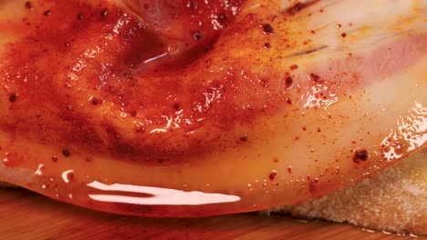 Detail-shot-of-seasoned-slice-of-ham-on-top-of-slice-of-bread,-macro-shot-in-4k