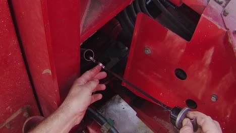 Checking-transmission-oil-level-in-a-large-articulated-tractor