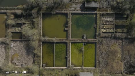 Old-Water-Treatment-Works,-Birds-Eye-View-Aerial-Overhead,-Open-Sewage-Pools,-UK-Winter-Spring-Season-Patterns,-And-Shapes