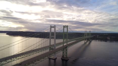 Rising-wide-drone-shot-of-Tacoma-Narrows-Bridge-at-sunrise,-circa-2015
