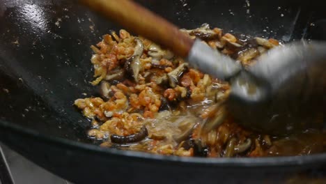 Oil-being-added-in-to-large-wok-for-frying-mushroom-and-shrimp-concoction-then-mixed-with-spatula