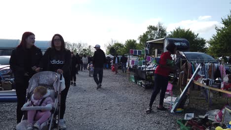 Bargain-hunters-browsing-busy-British-weekend-car-boot-sale-for-used-unwanted-goods