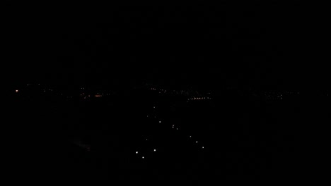 Aerial-Rising-Over-Dark-Night-Sky-View-Over-Town-Of-Estepona