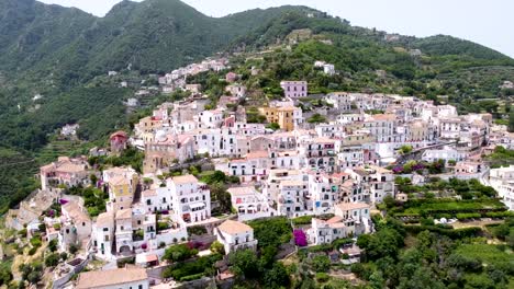 Aerial-shot-pan-right-of-an-Italian-village-in-Amalfi-coast,-in-a-mountain-landscape