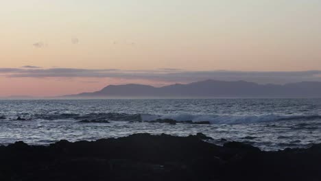 The-early-morning-sunrise-glow-over-the-ocean-towards-wilson-prom-country-mountains-in-Australia