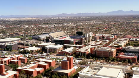 Drone-circling-University-of-Tucson-Arizona-and-Wildcat-Stadium-with-mountains-in-distance