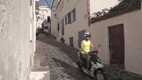 Slow-motion,-male-tourist-riding-moped-scooter-down-narrow-European-alleyway