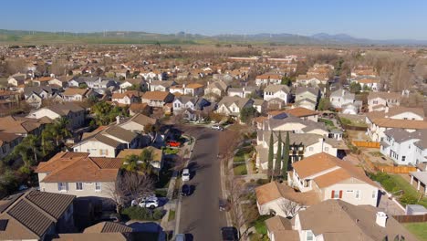 Aerial-view-flying-above-new-housing-development-neighbourhood-rooftops-in-Central-valley-of-California