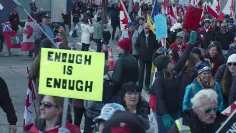 Crowd-marching-Enough-is-enough-sign-Calgary-protest-4th-March-2022