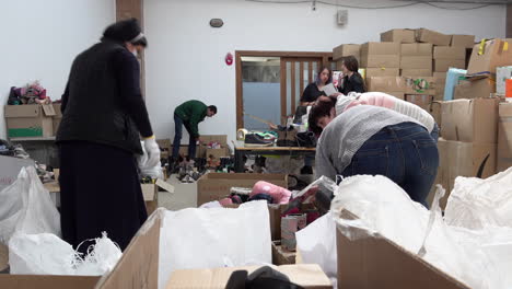 A-nun-works-with-volunteers-to-organise-boxes-of-donated-clothing-in-the-Art-Palace-of-Lviv-that-has-been-converted-into-the-largest-aid-centre-in-the-region-during-the-Russian-war-against-Ukraine